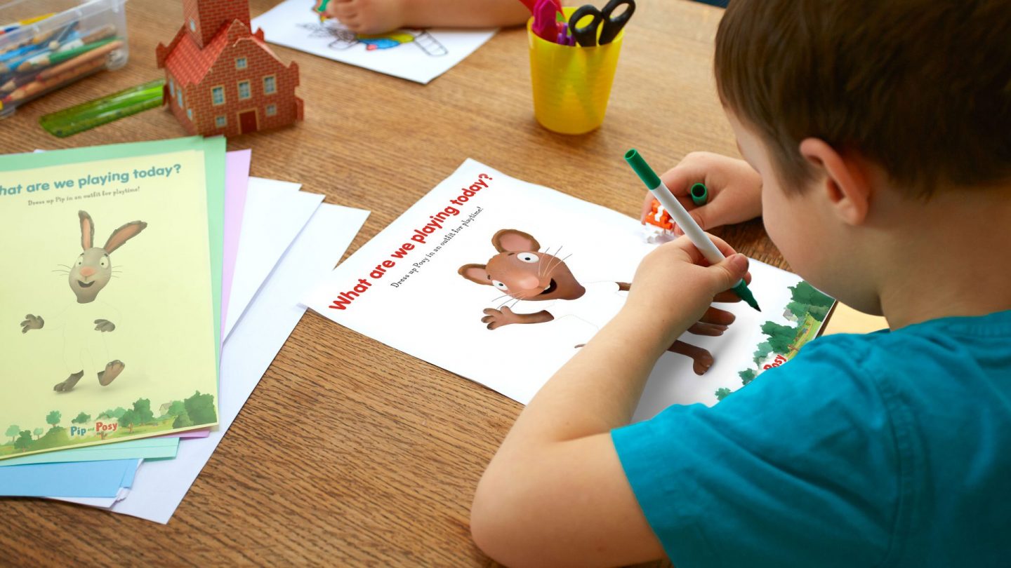 A child colouring in a Pip & Posy activity sheet