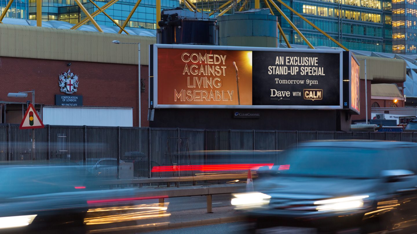 Night time Canary Wharf roadside billboard of the UKTV Dave Calm campaign.